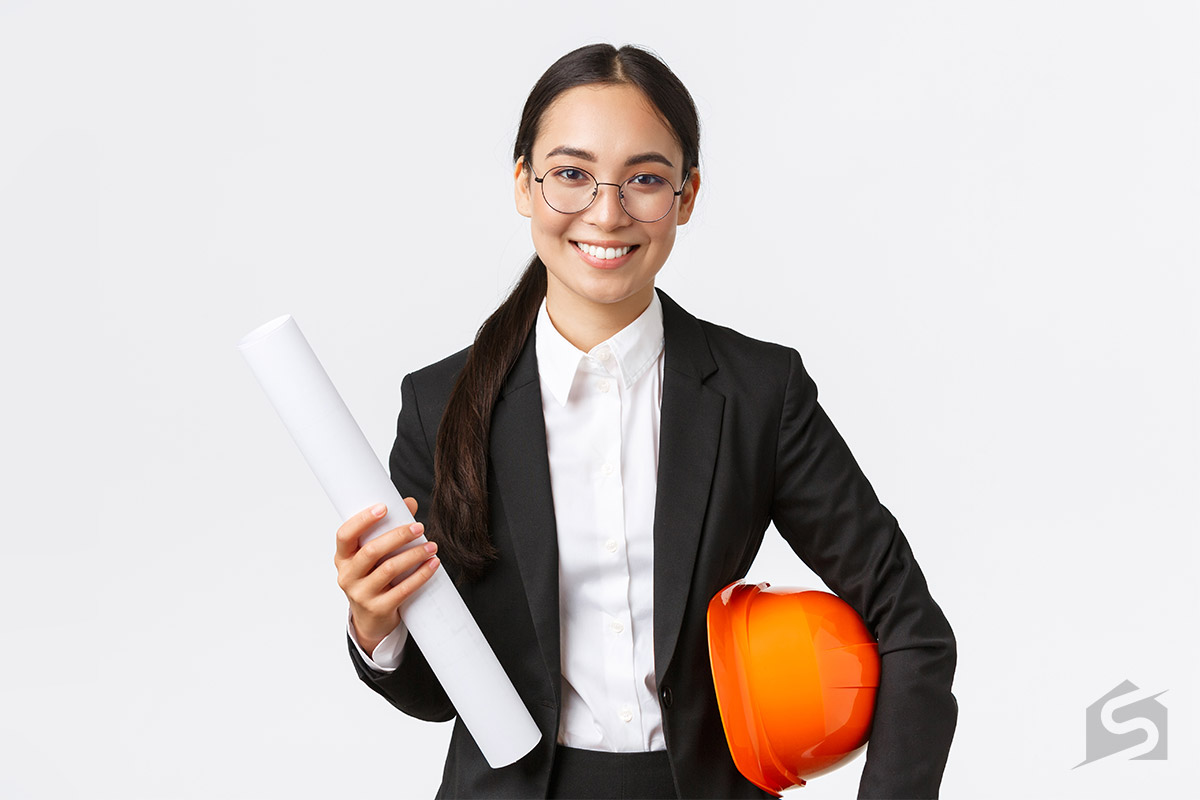 Architect holding a drafting paper and safety helmet